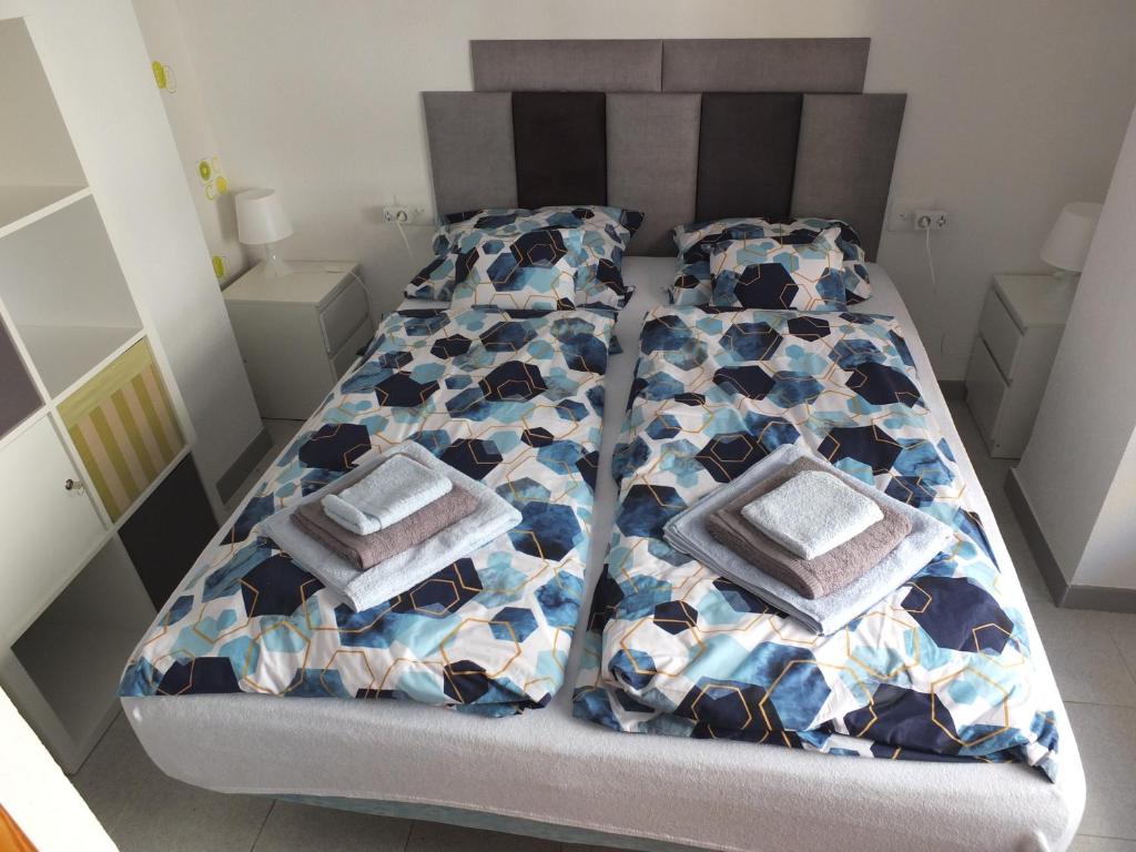 a bed with two pillows on it in a room at Neptuno Playa San Antonio in Cullera