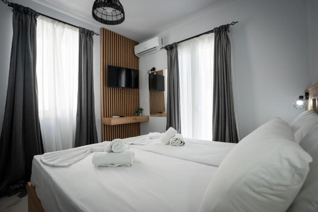 a hotel room with two beds with towels on them at Aggire Zante Luxury Residence in Zakynthos