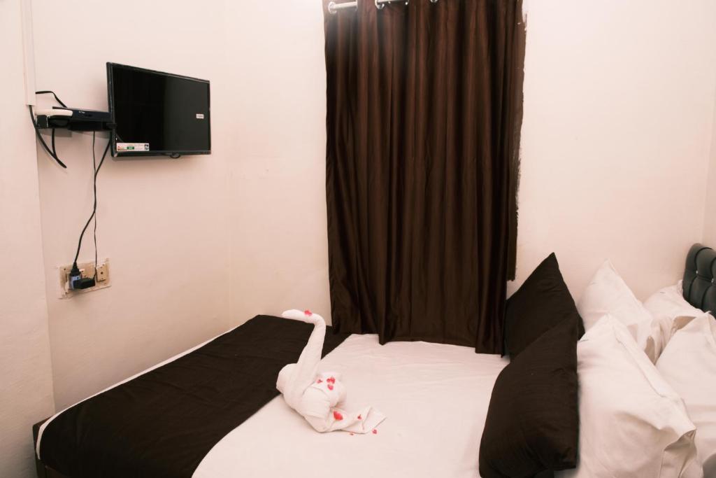 Postel nebo postele na pokoji v ubytování Aum Karthikeya Residency - Near Chennai Railway Station