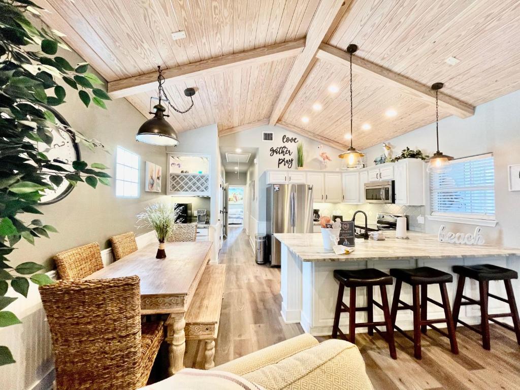 an open kitchen with a large wooden table and chairs at SeaKing Relaxation where the waves meet the shore and time slows down in Port Aransas