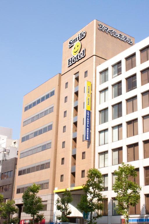 a building with a hotel sign on top of it at Smile Hotel Tokyo Nihonbashi in Tokyo