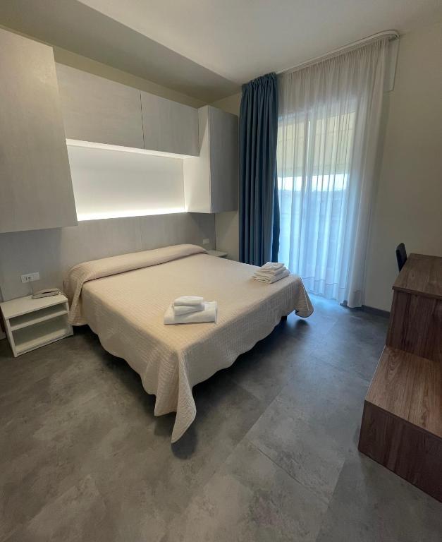 Postel nebo postele na pokoji v ubytování Hotel Catto Suisse