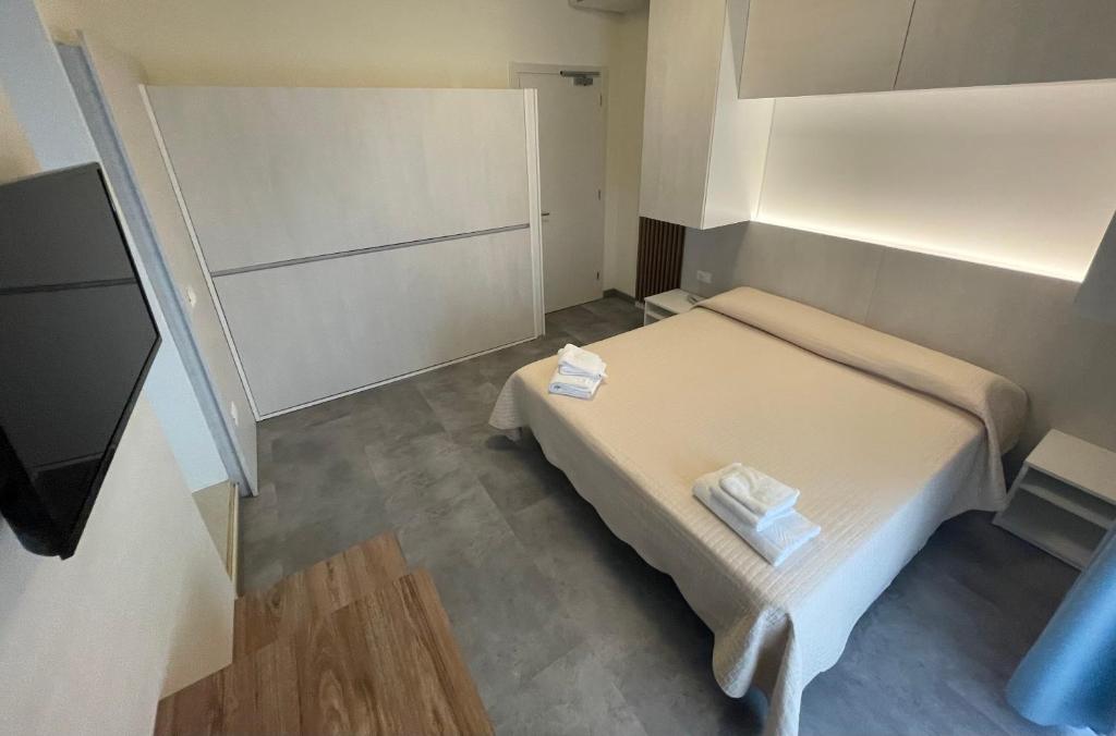 Postel nebo postele na pokoji v ubytování Hotel Catto Suisse