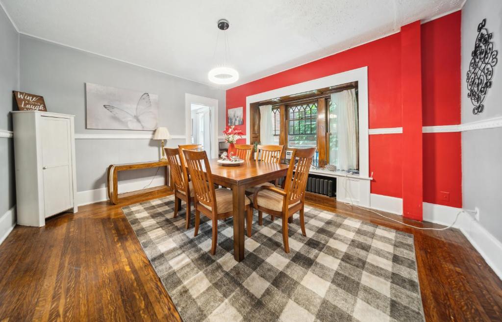 a dining room with red walls and a table and chairs at Pura Vida, Live Pure! 2 b, 1 b. in Akron