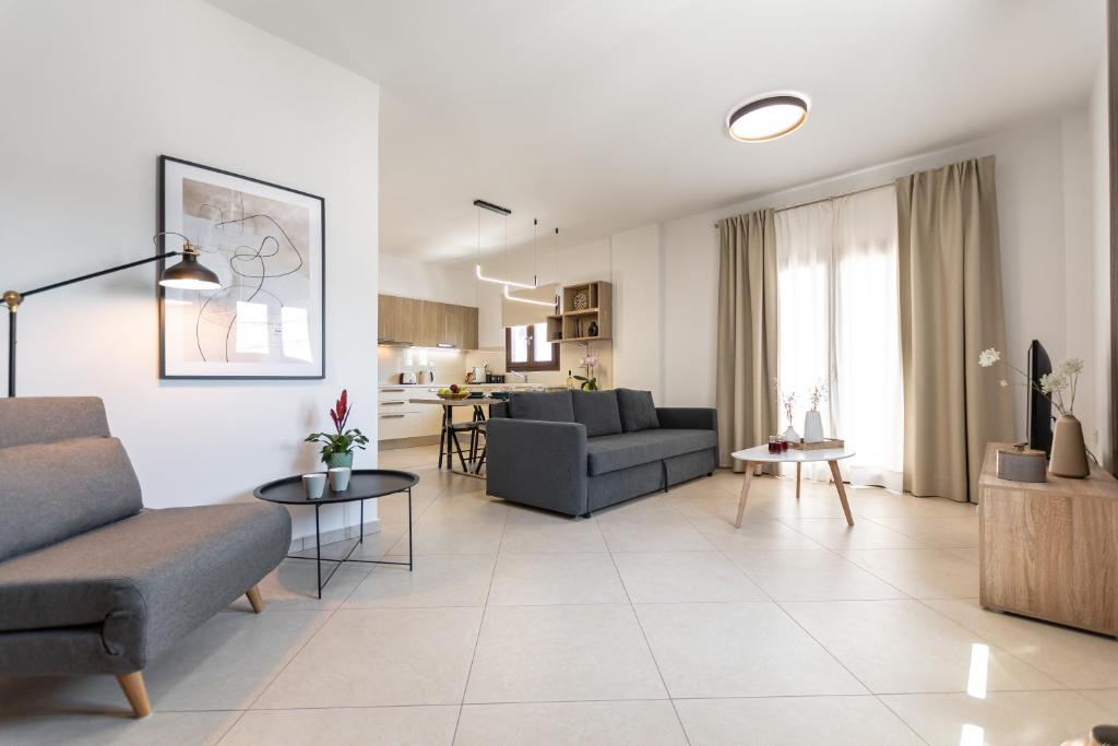 a living room with two couches and a table at Naxos Alma House in Naxos Chora