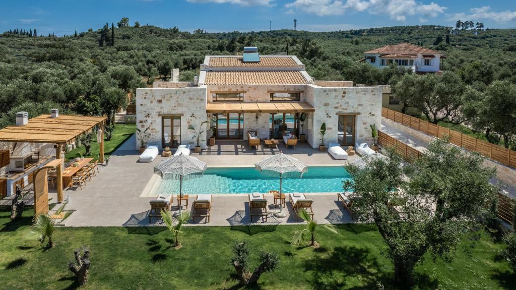 an aerial view of a villa with a swimming pool at White Stone Luxury Villa in Lithakia
