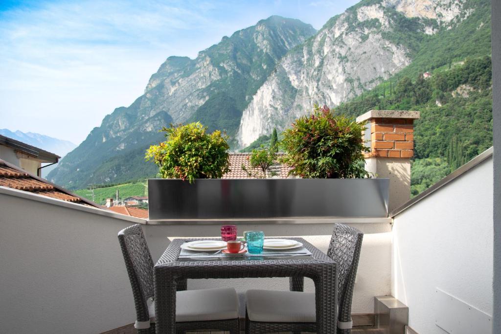 a table on a balcony with a view of mountains at Charming Loft Lake Garda in Riva del Garda