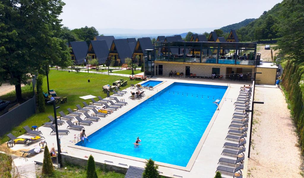 an overhead view of a swimming pool with chairs and a building at Reserve Resort Lagodekhi in Lagodekhi