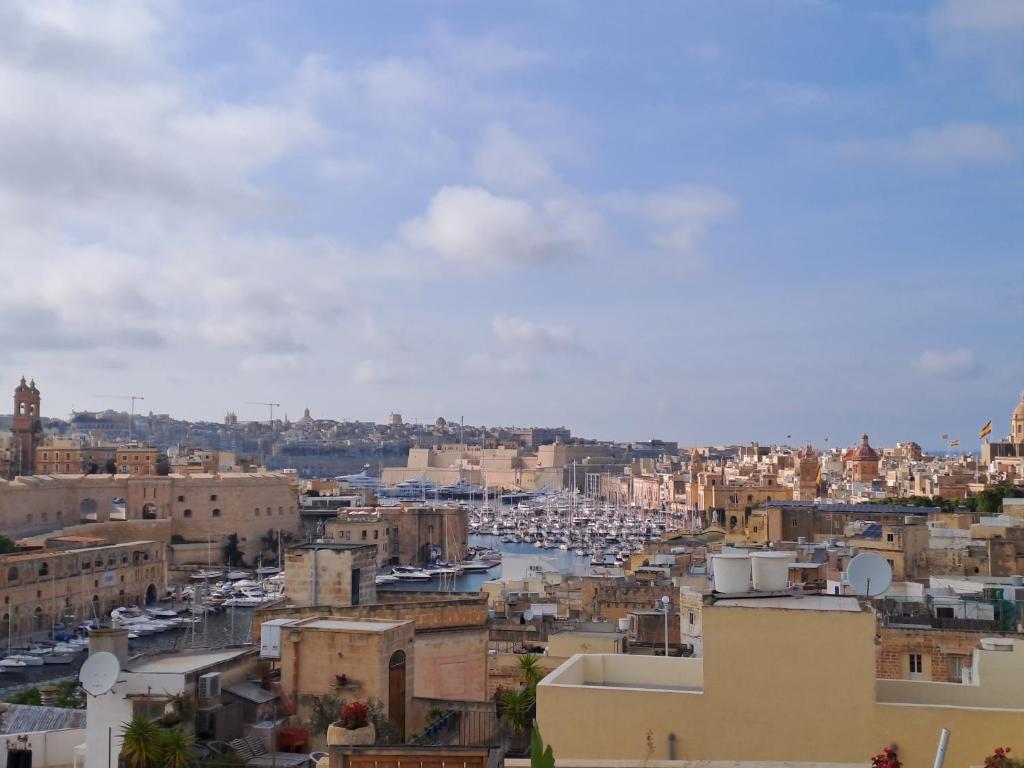 a view of a city with buildings and a harbor at No18 Cospicua in Cospicua