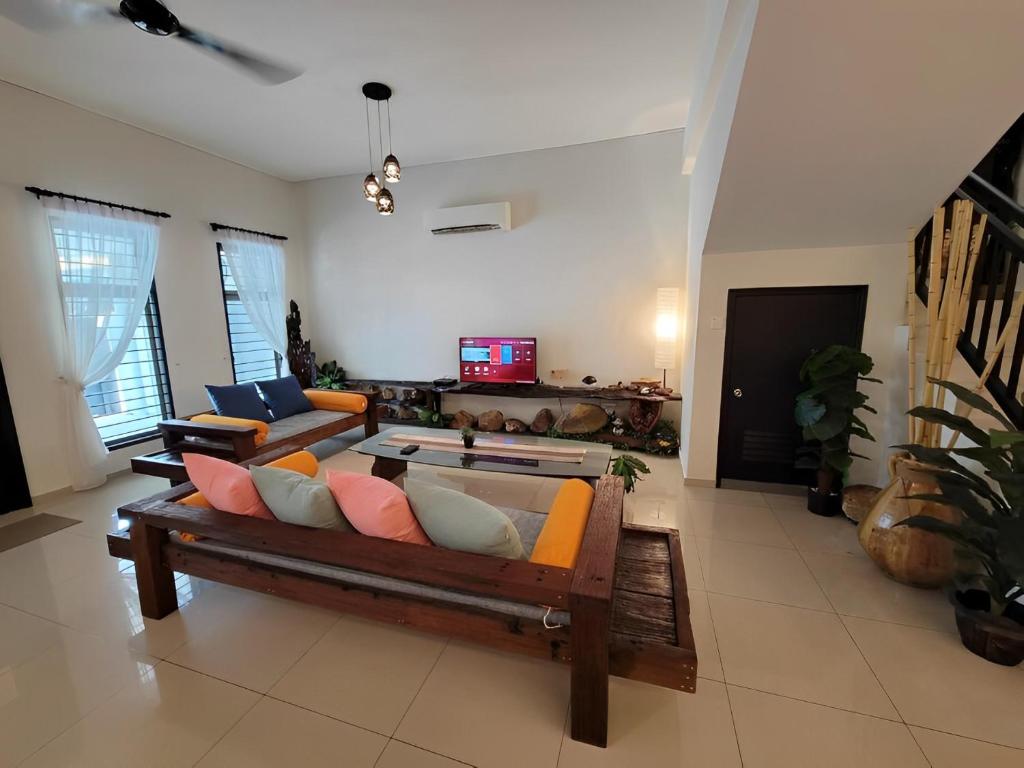 a living room with a couch and a table at Malacca City Center Town House by 360HOME in Melaka