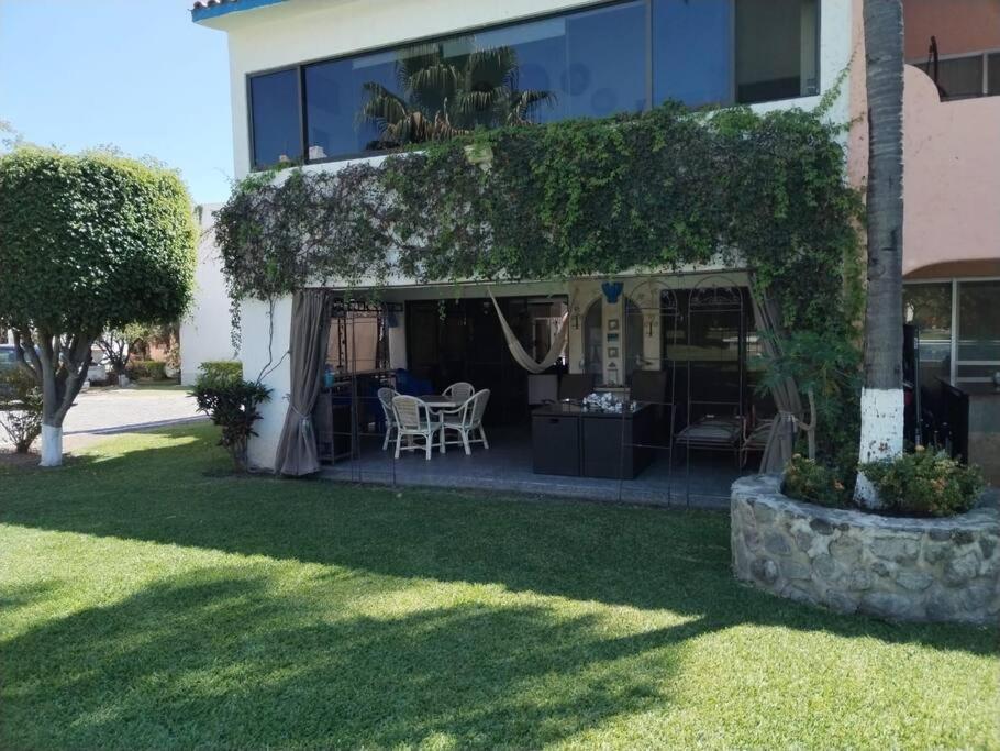 特米斯科的住宿－Casa en Club de Golf Santa Fe，院子内带桌椅的房子