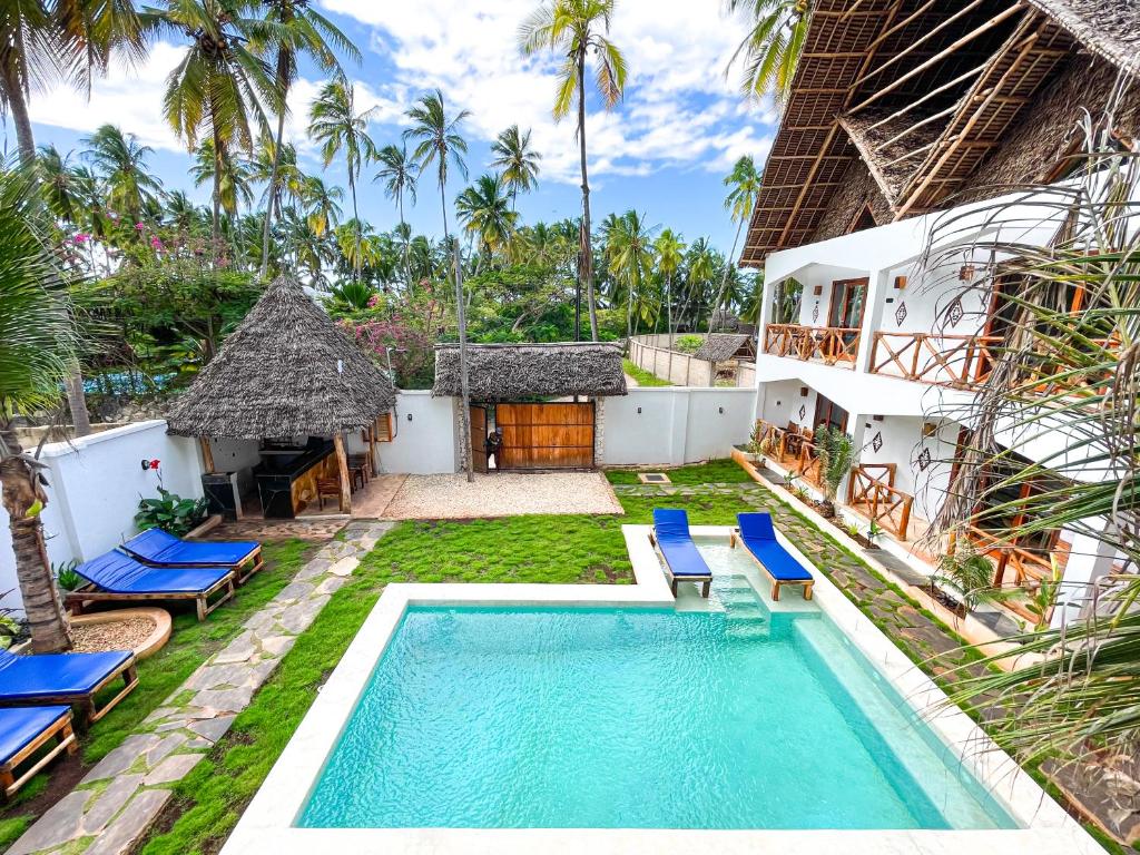 an image of a villa with a swimming pool at Mambo Cabana in Pwani Mchangani