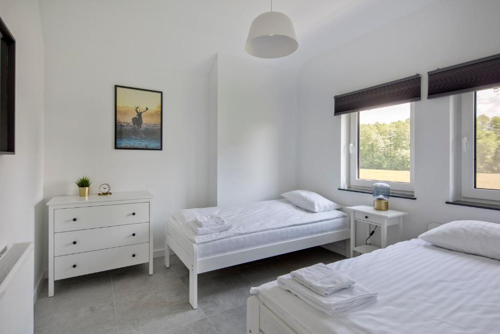 Postel nebo postele na pokoji v ubytování Apartamenty Zielona Lipka