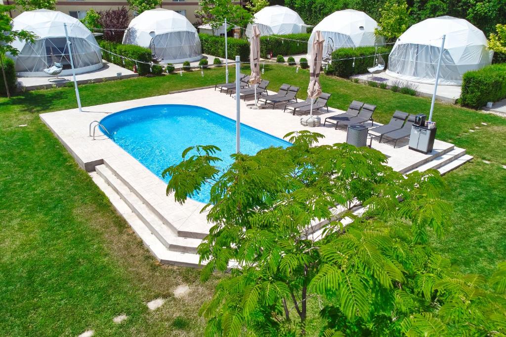 una imagen de una piscina en un patio con cúpulas en Seagloo Glamping - Adults Only en Costinesti