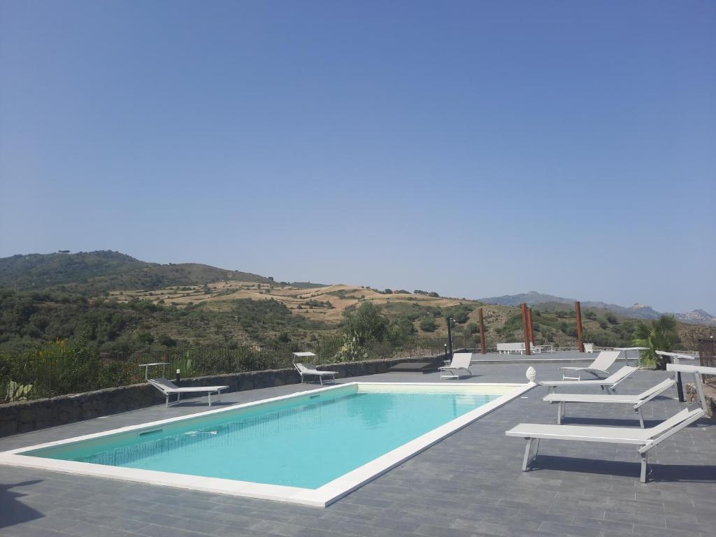 een zwembad met 2 ligstoelen bij SIeSI in Piedimonte Etneo