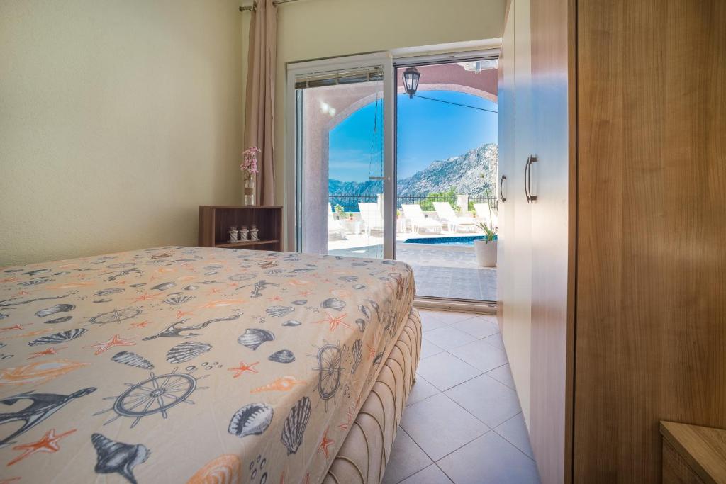 a bedroom with a bed and a view of a pool at Boka bay in Kotor