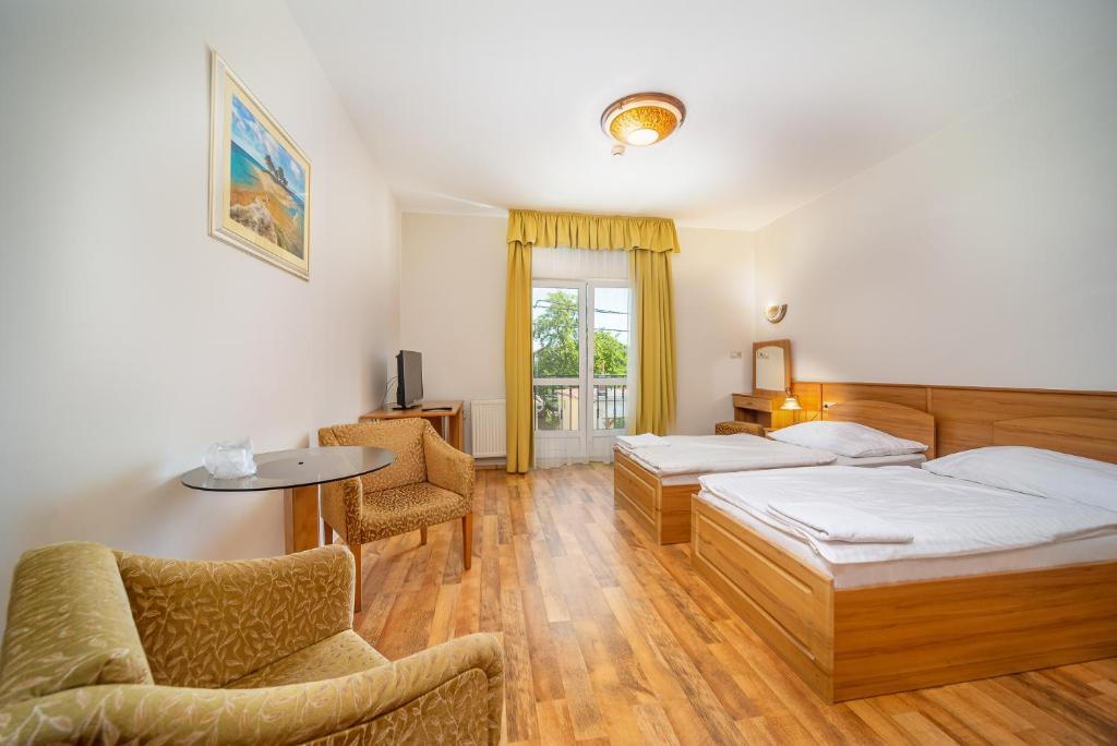 Postel nebo postele na pokoji v ubytování Nefelejcs Hotel