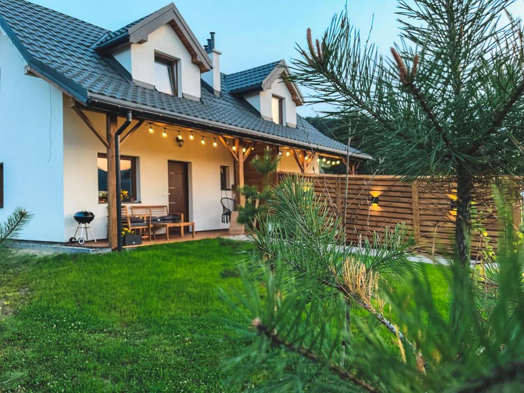 a house with a patio and a fence at ZACISZE W MIEŚCIE in Ustrzyki Dolne