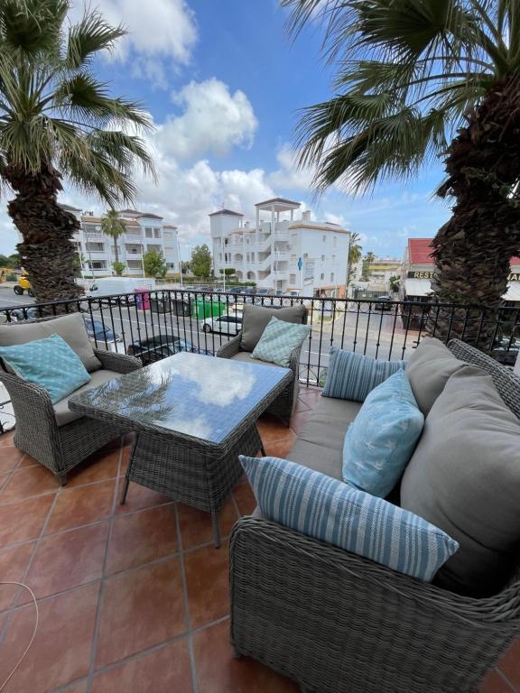 a patio with a couch and chairs and a table at Villamartin Plaza No 154 in Orihuela