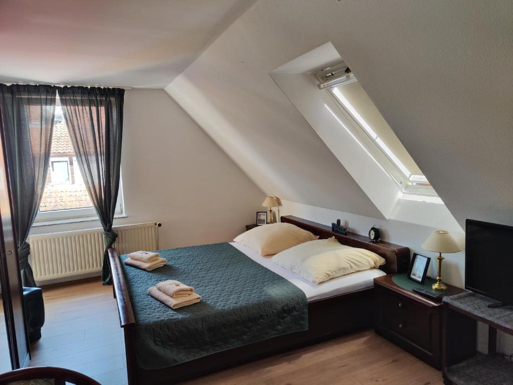 a bedroom with a bed and a window at Pension Weidengrund in Walsrode