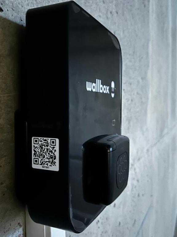 a black soap dispenser attached to a wall at Résidence CATALINA in Saint-Florent