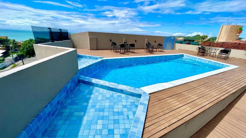 a swimming pool on the roof of a building at Hotel Antibes in Natal