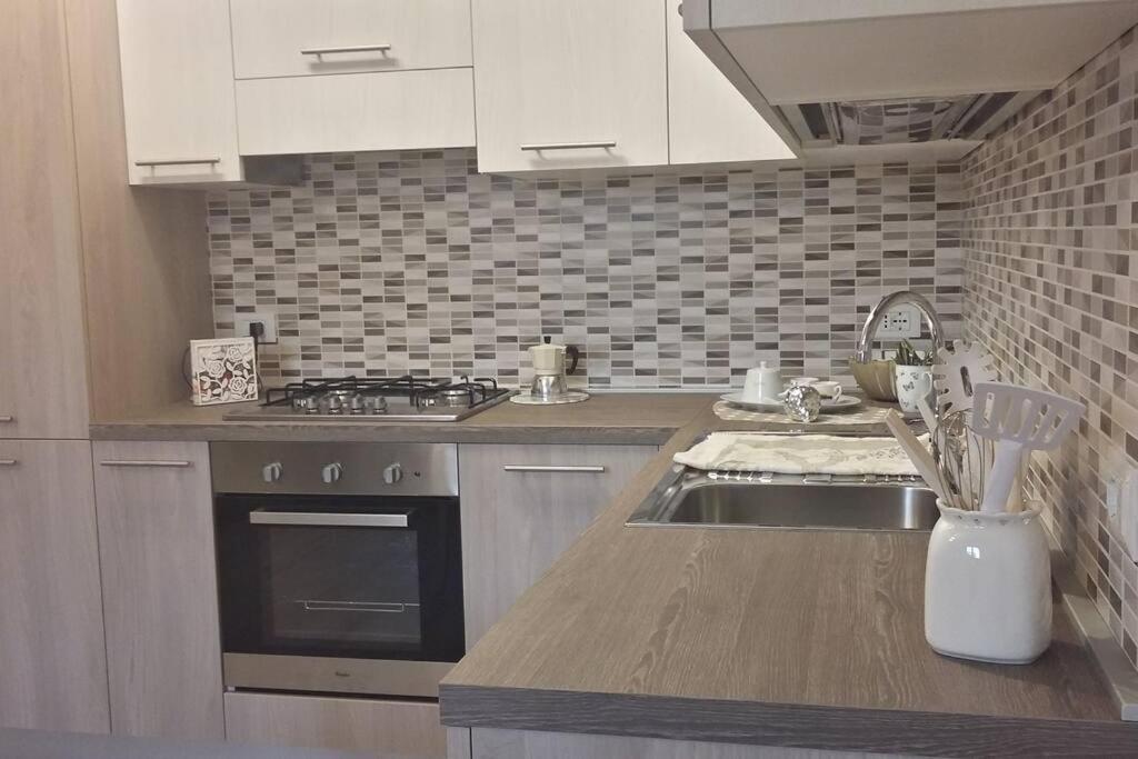 a kitchen with a sink and a stove at La Casa di Paola in Cavaion Veronese