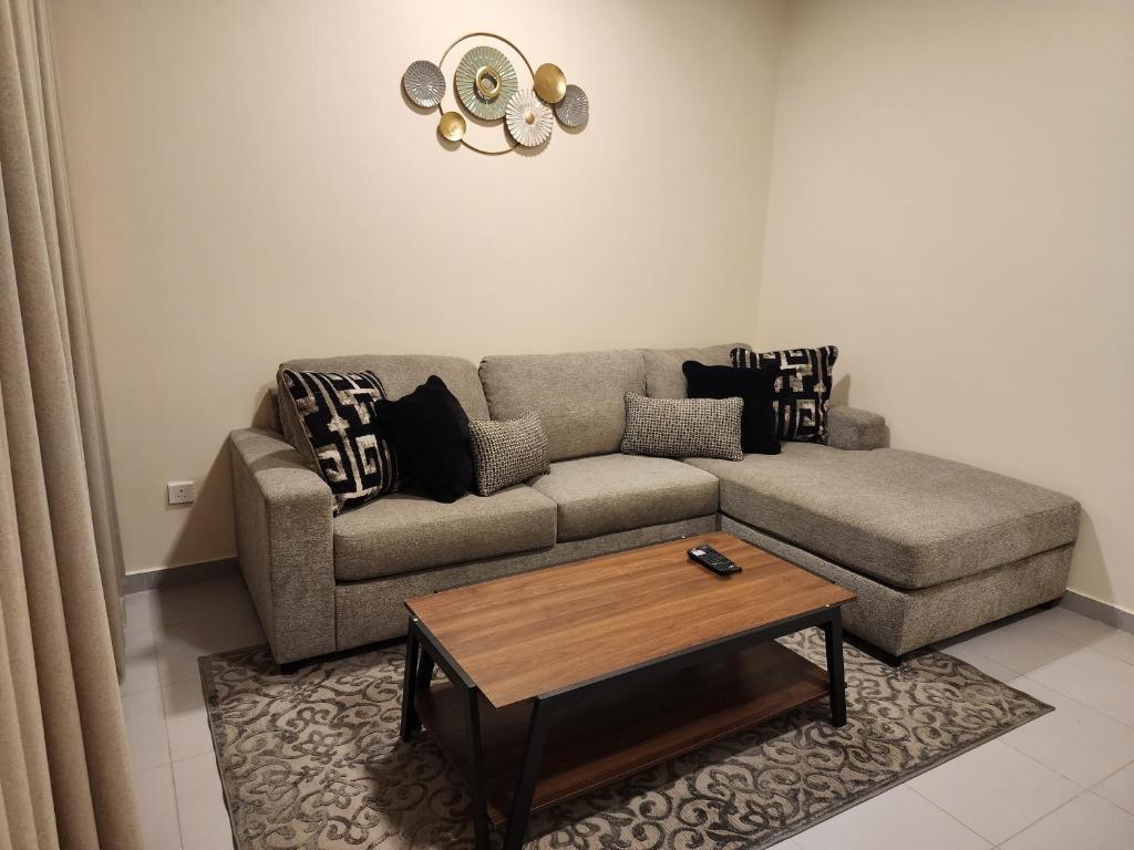 a living room with a couch and a coffee table at Nesaj Villa in Dammam