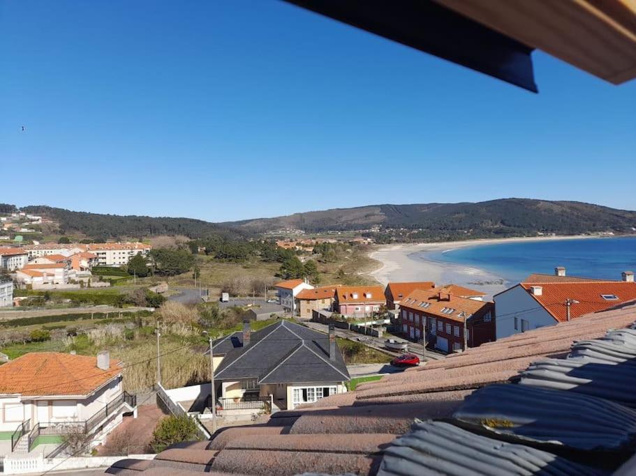 a view of a town with houses and a beach at Atico Finisterre in Fisterra