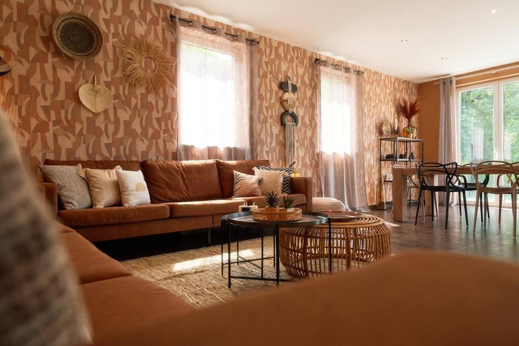 a living room with a couch and a table at La Reserve in Brugelette