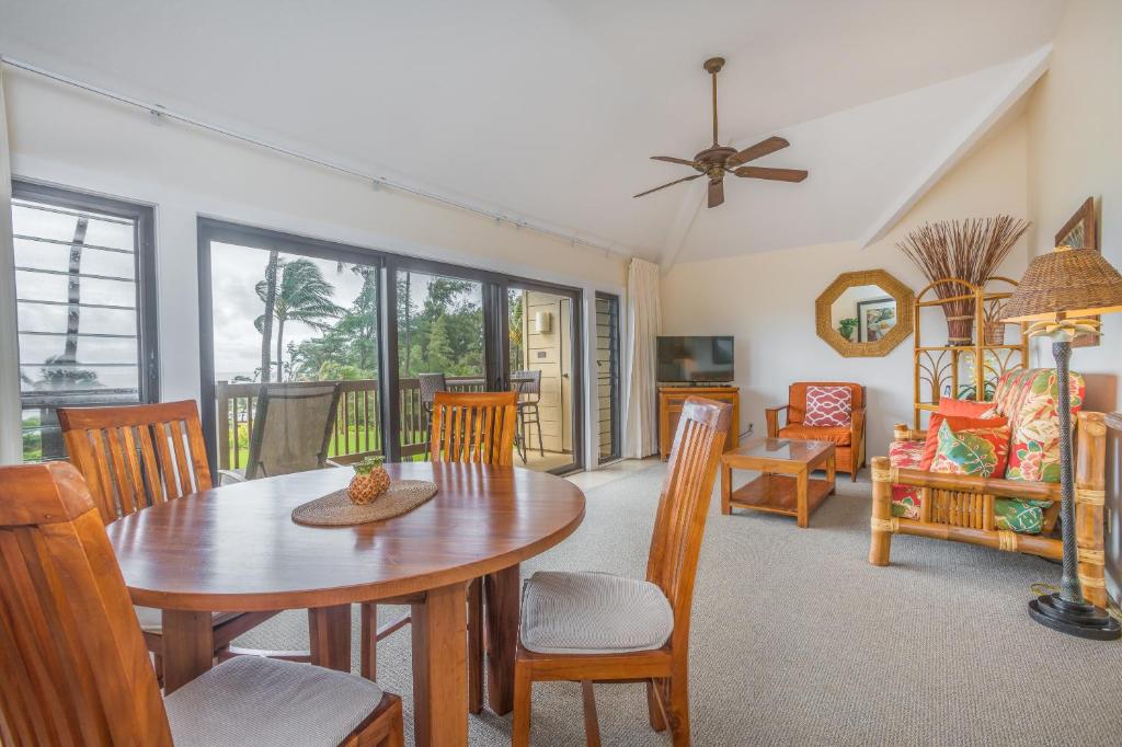 a dining room with a table and chairs at Oceanfront 1 BR Condo at Kaha Lani KL309 in Kapaa