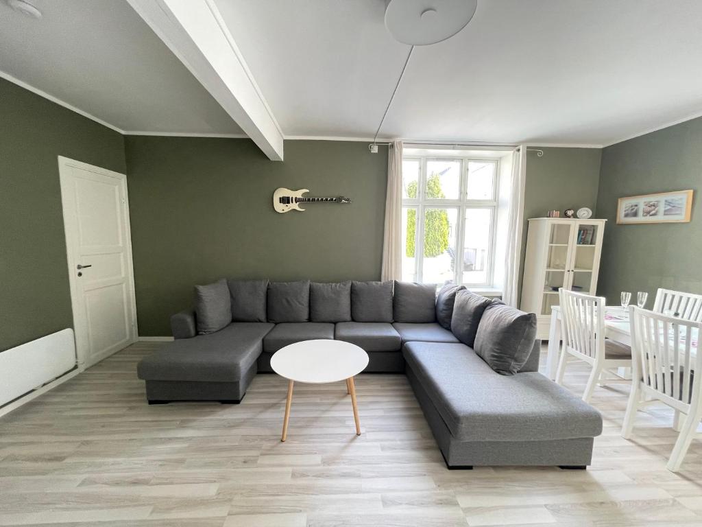 a living room with a couch and a table at 1St Floor Oasis - Parking/WiFi in Stavanger