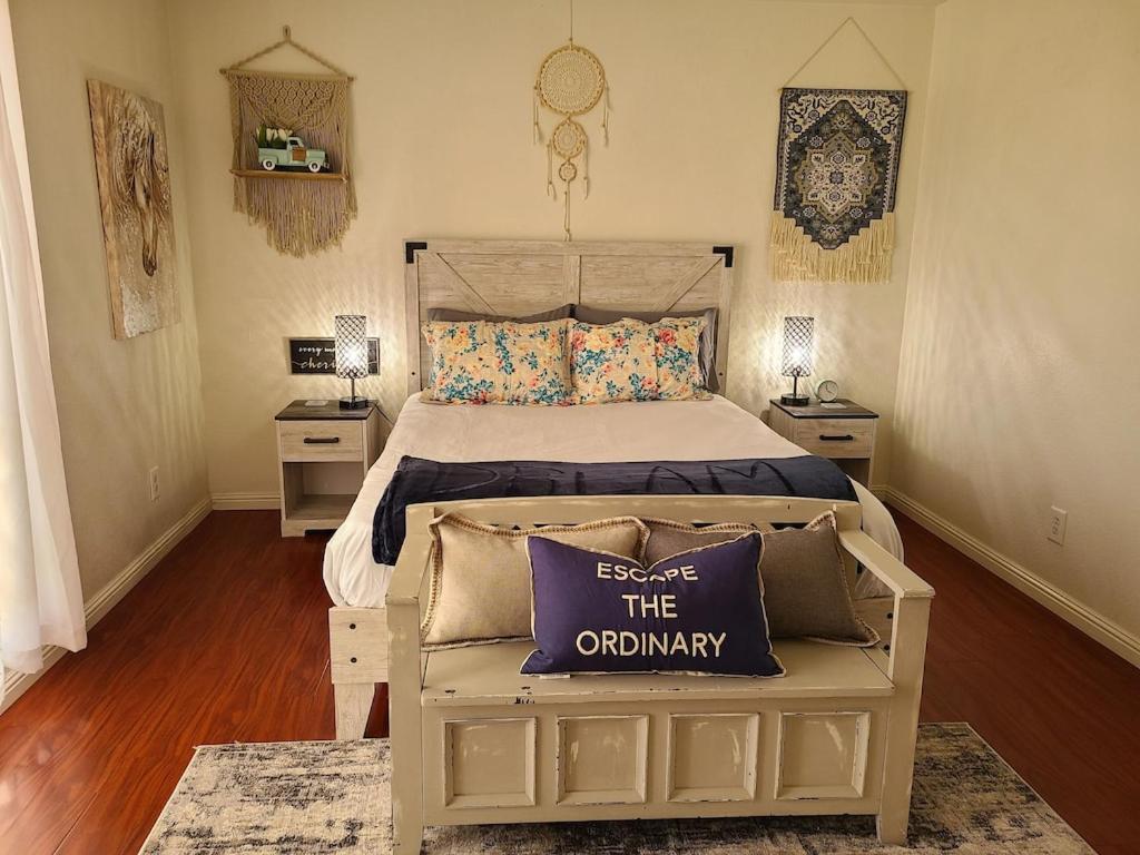 a bedroom with a bed with a purple pillow on a bench at 2bed 1 bath condo near Nellis afb & the strip in Las Vegas