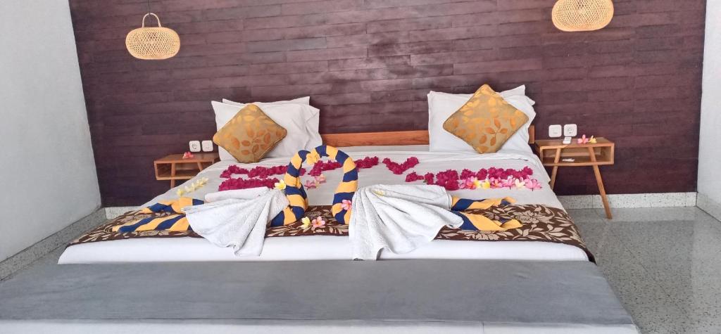 a bedroom with two beds and two night stands at THE OWN PENIDA COTTAGE & SPA in Nusa Penida