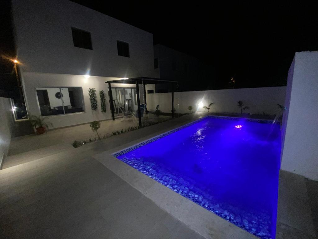 a swimming pool at night with blue water at Villa Golden Dream in San Felipe de Puerto Plata