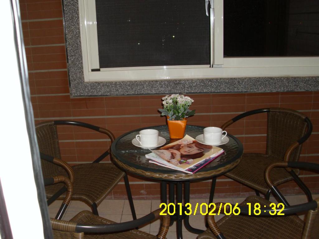 a table with two chairs and a table with a dog on it at Xinchuan B&amp;B in Dayi