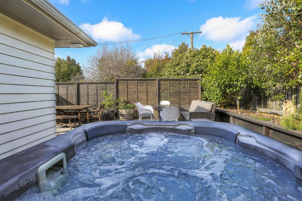 a hot tub in the backyard of a house at Redwoods Retreat in Rotorua