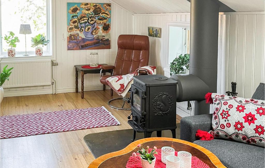 a living room with a stove and a couch at Stunning Home In Vstervik With Kitchen in Västervik