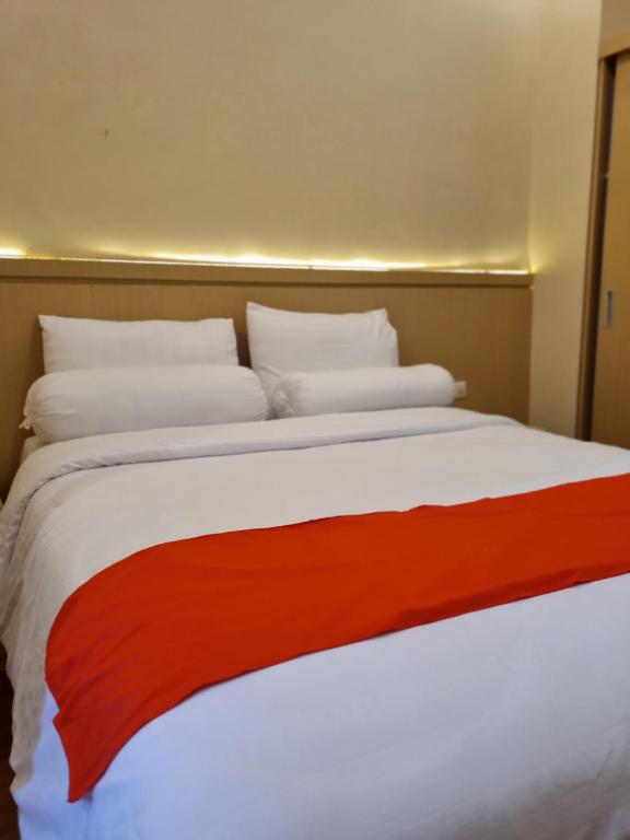 Postel nebo postele na pokoji v ubytování core inn juwita hotel