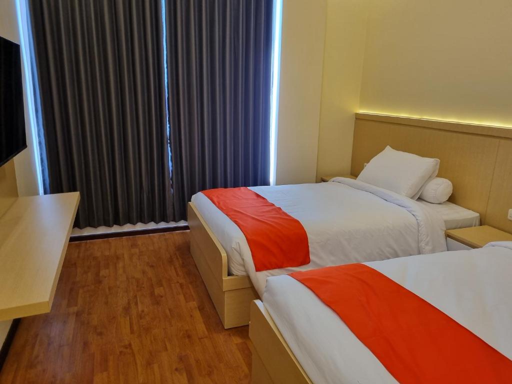 Postel nebo postele na pokoji v ubytování core inn juwita hotel