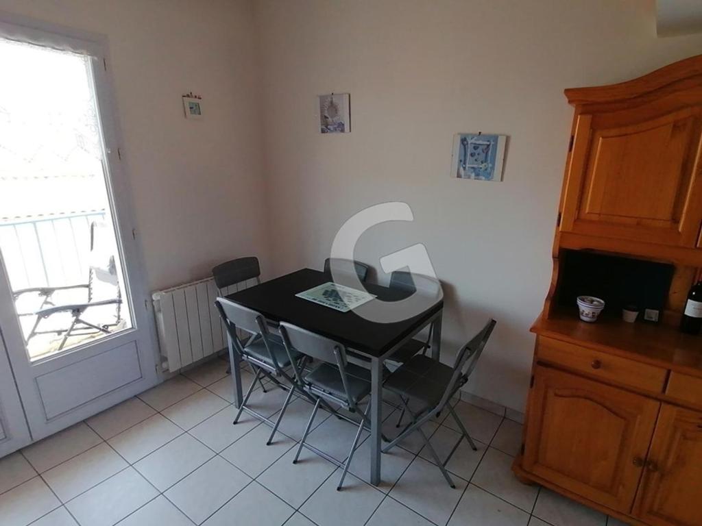 a dining room with a table and chairs and a window at Appartement La Tranche-sur-Mer, 3 pièces, 5 personnes - FR-1-357-309 in La Tranche-sur-Mer