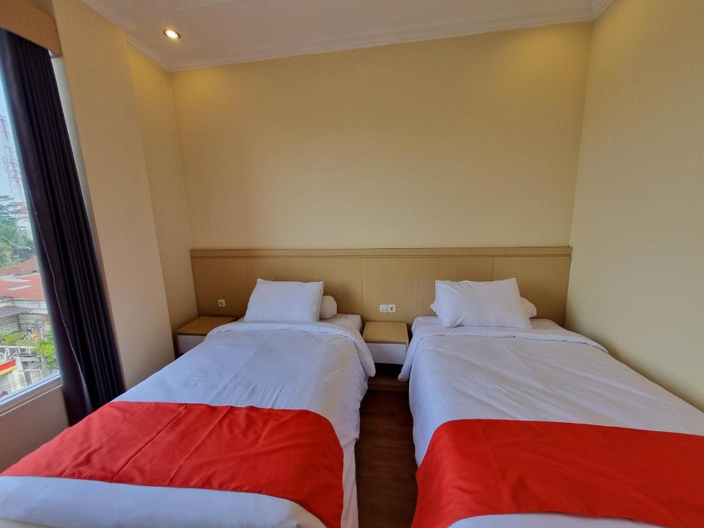 Postel nebo postele na pokoji v ubytování core inn juwita hotel