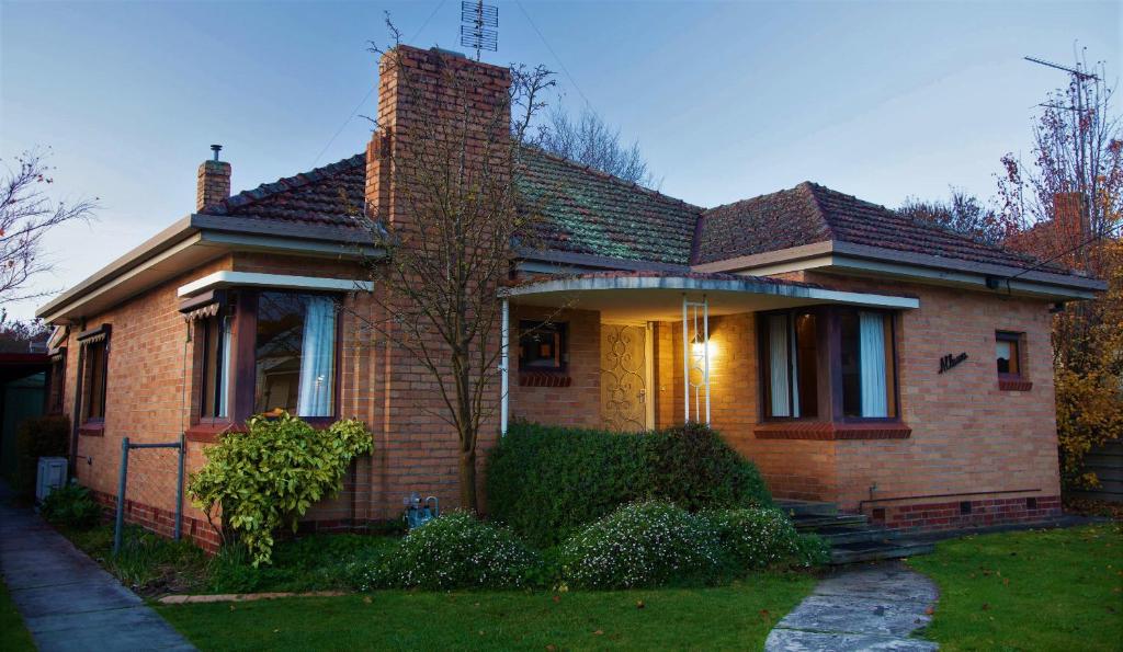 a brown brick house with a porch at Allawa- Central & Cosy Ballarat Art Deco in Ballarat