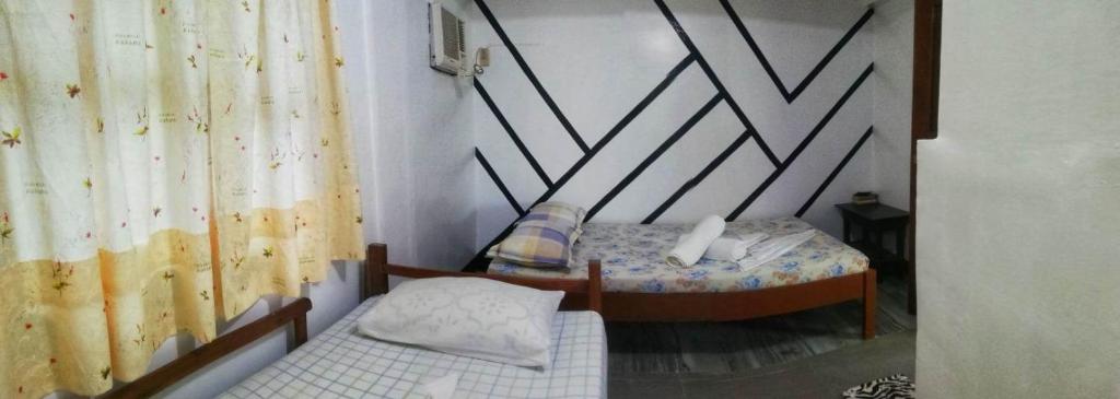 Postel nebo postele na pokoji v ubytování Blessed Inn Annex