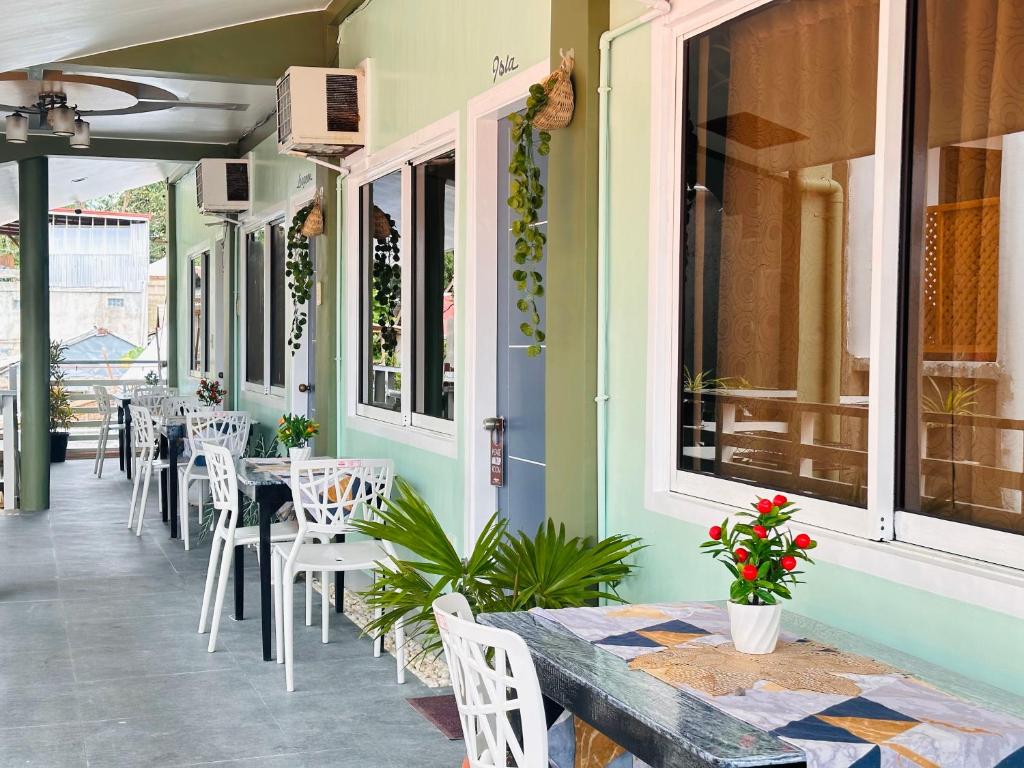 a restaurant with tables and chairs on a patio at Panari Lodge El Nido in El Nido