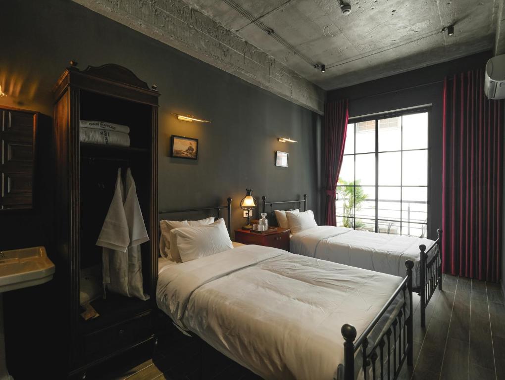 Giường trong phòng chung tại The Chum Boutique