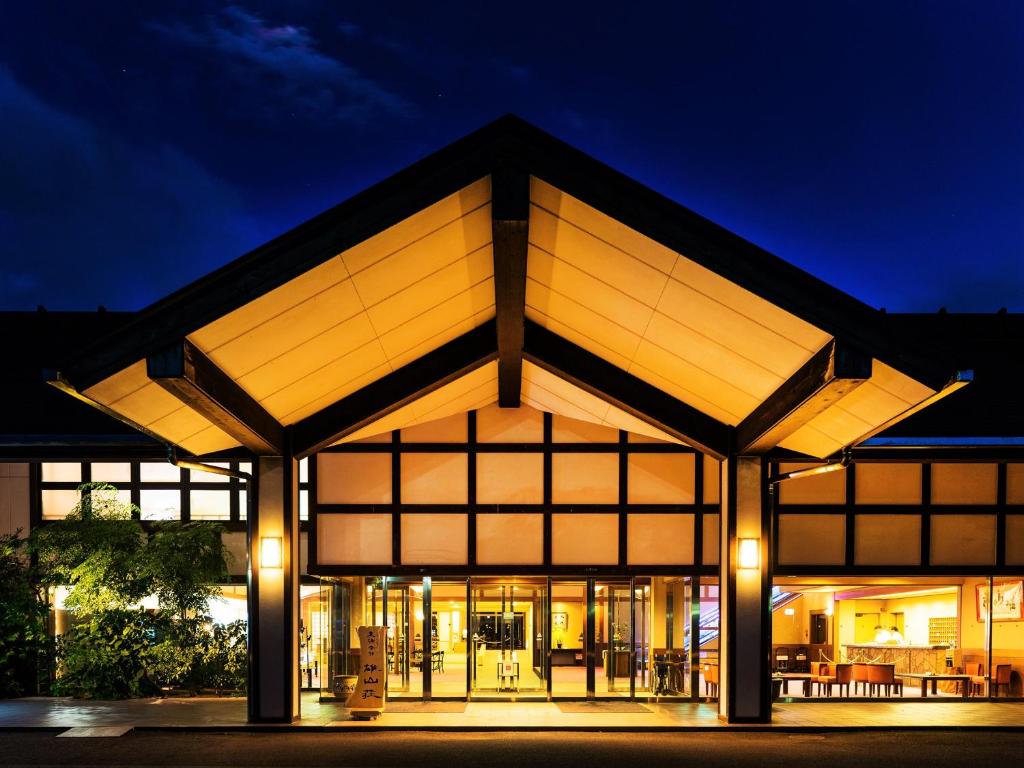 a building with large windows at night at Yuzanso in Otsu