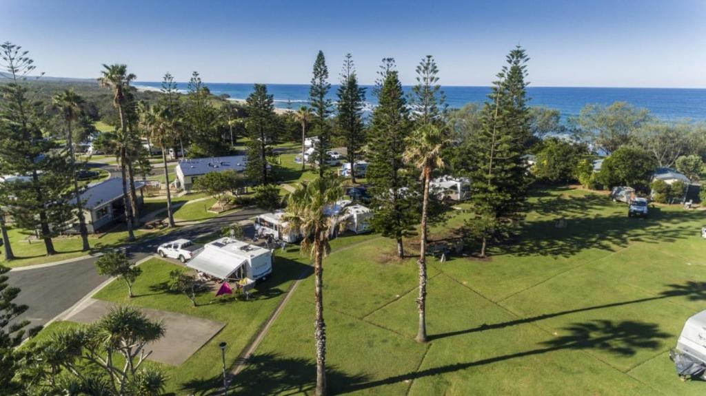 an aerial view of a park with a rv and the ocean at Reflections Corindi Beach - Holiday Park in Corindi