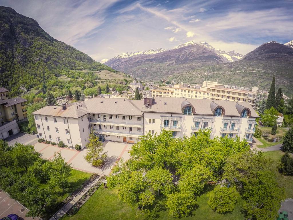 an aerial view of a building with mountains in the background at Hotel & Bildungshaus St. Jodern in Visp