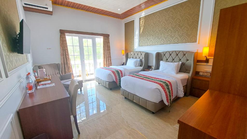 Postel nebo postele na pokoji v ubytování Gili Beachfront Suites